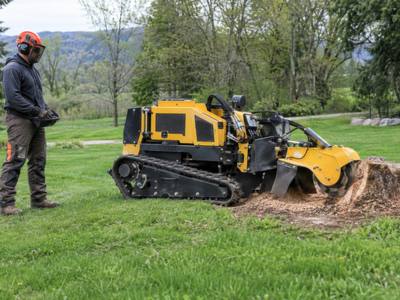Stump grinder finishing a pass around the base of a stump
